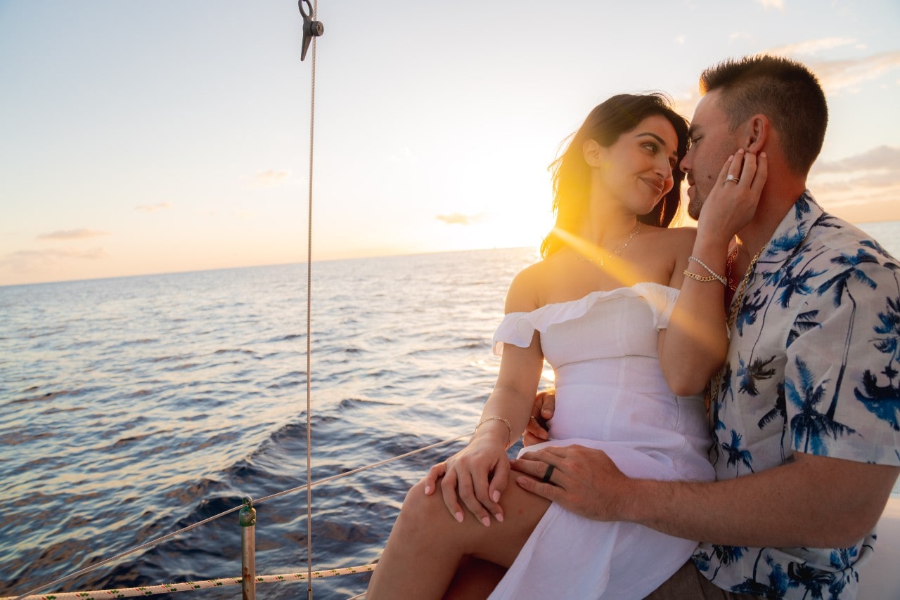 A newly wed couple enjoying the sunset on a cruise