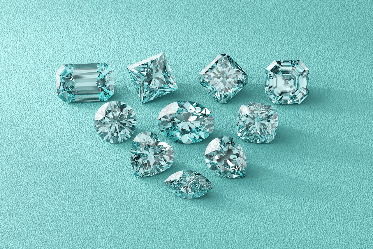 Ten diamonds of different cuts on a textured turquoise surface
