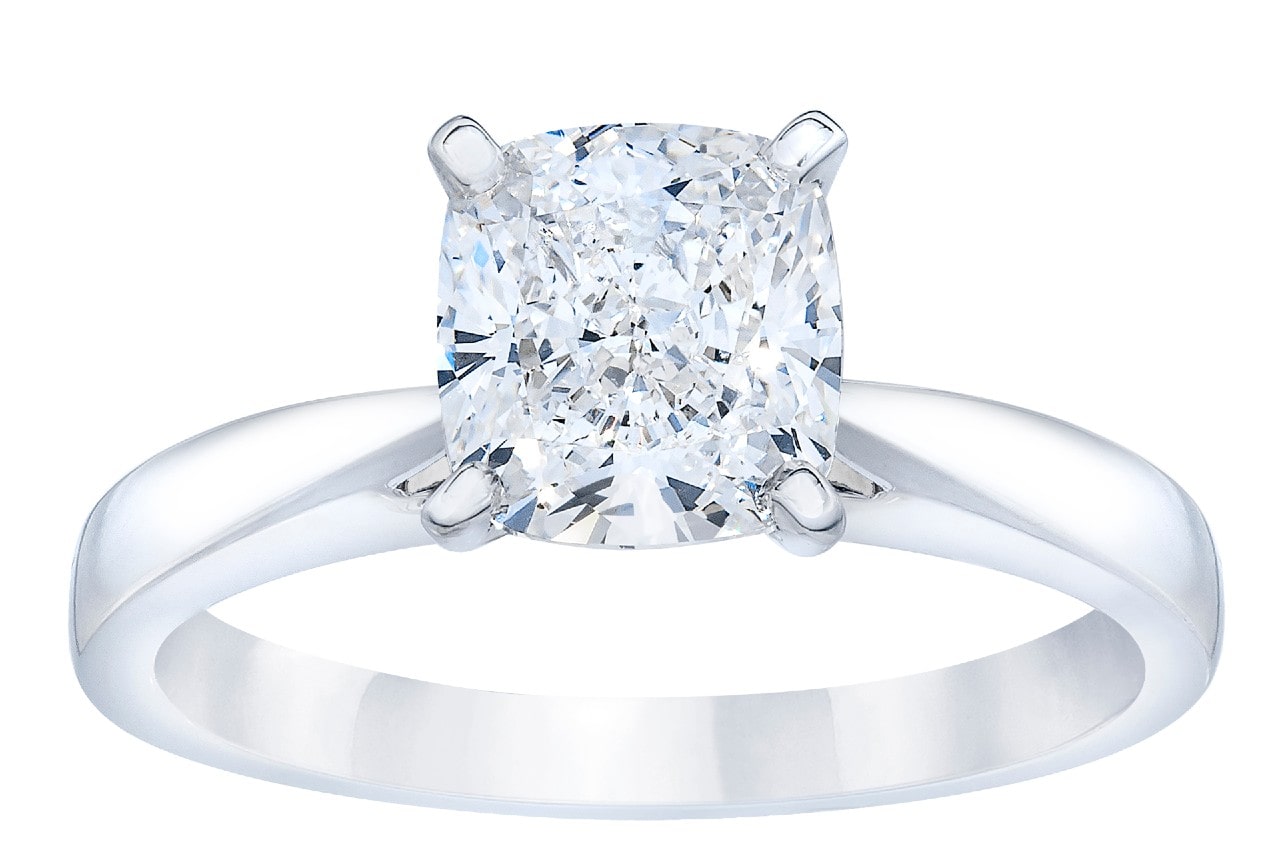 Close-up image of a solitaire, cushion cut engagement ring