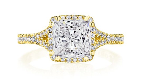 a yellow gold engagement ring with split shanks and a princess cut center stone