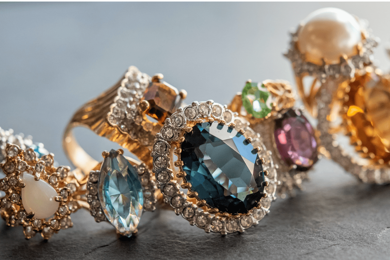 a multitude of gemstone rings of all different colors arranged together