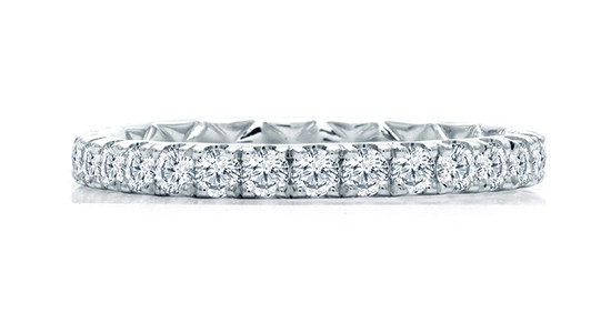 a silver eternity wedding band featuring an unbroken line of diamonds