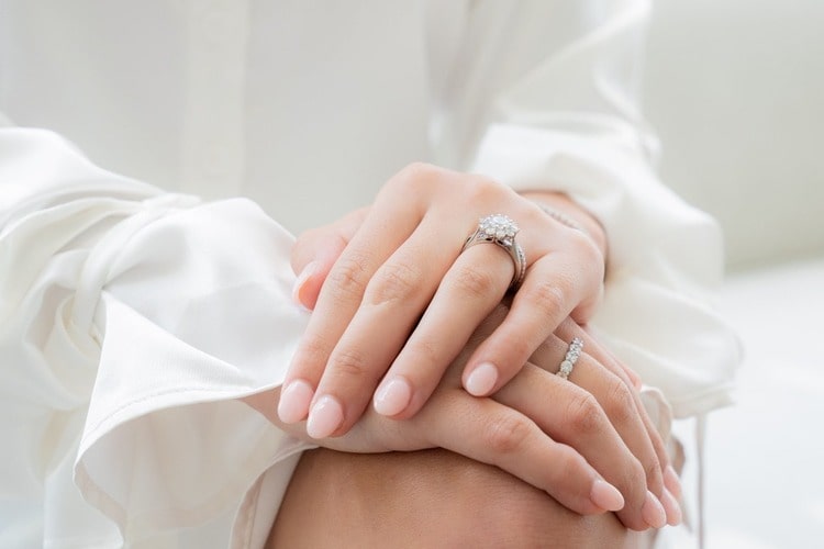 A woman with a floral halo engagement ring