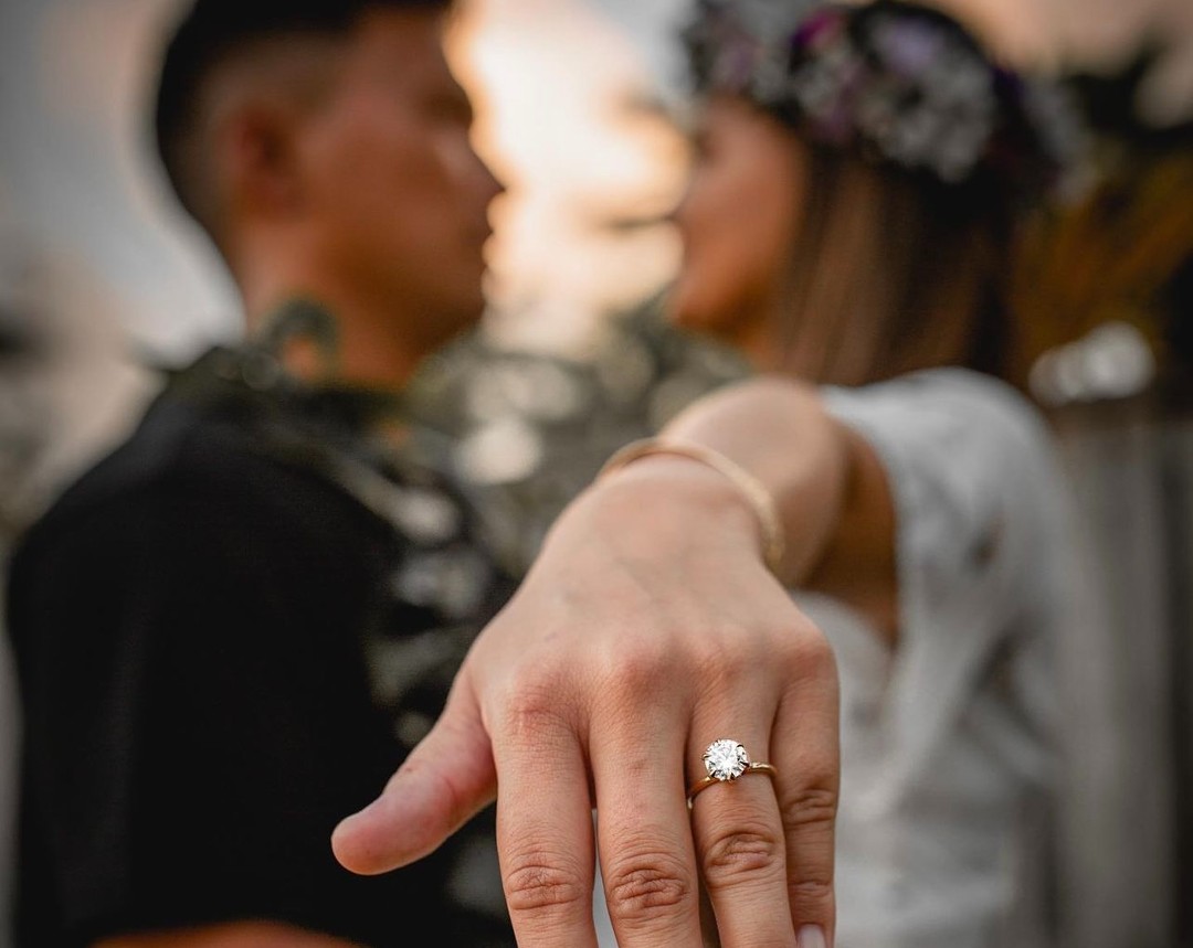 A couple that just got married in Hawaii, photo focusing on her round cut diamond solitaire