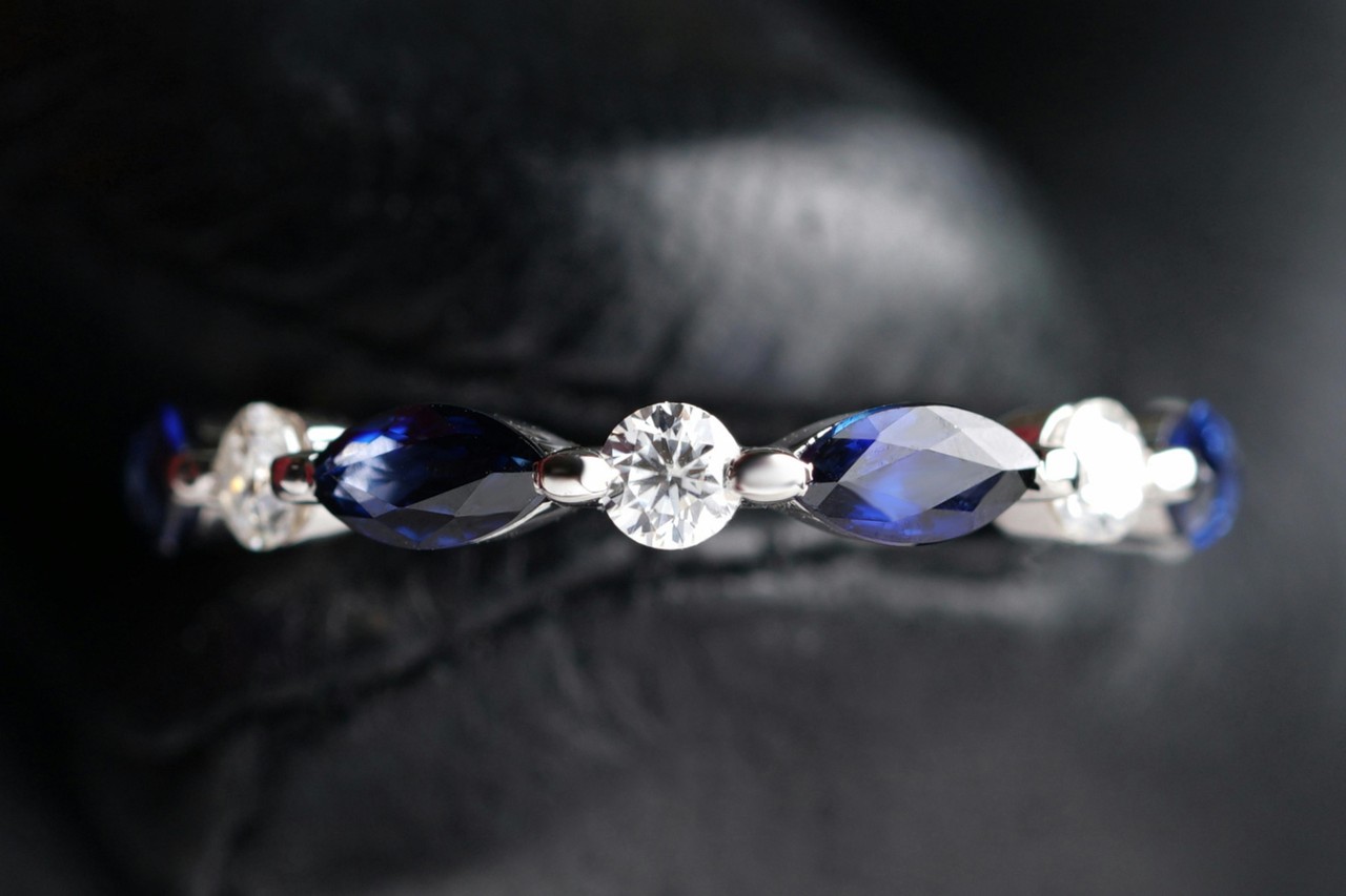 a diamond and sapphire wedding band in a white gold setting